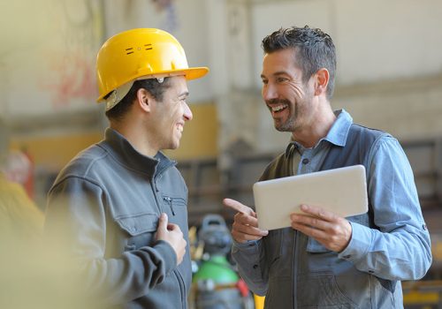 workers talking and laughing at a factory workers talking and laughing at a factory